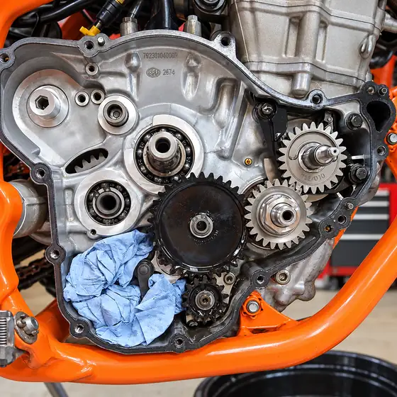 Open engine casing with the original gears, a blue cloth packed into the crankcase