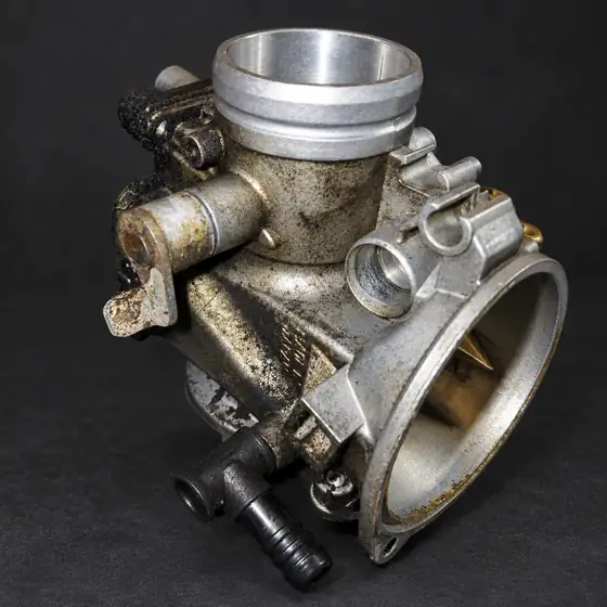 Carburettor covered in grime before cleaning